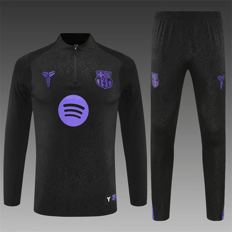 Black barcelona sports outfit with purple logos on a gray background