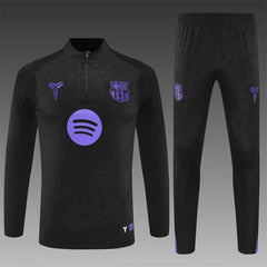 Black barcelona sports outfit with purple logos on a gray background